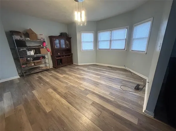 a view of empty room with stairs and fan