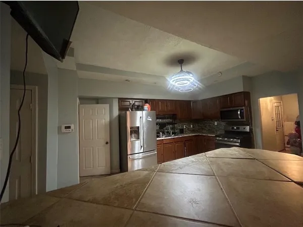 a kitchen with granite countertop a stove and a microwave