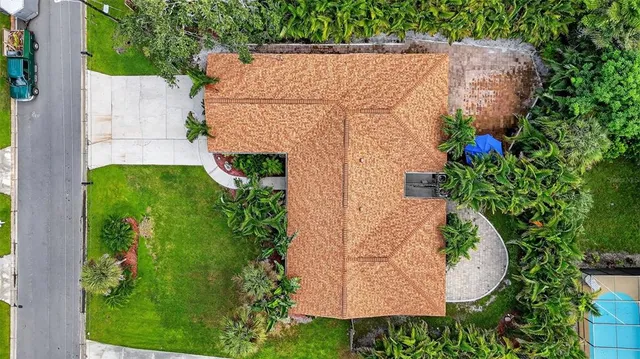 an aerial view of a house with a yard and garden