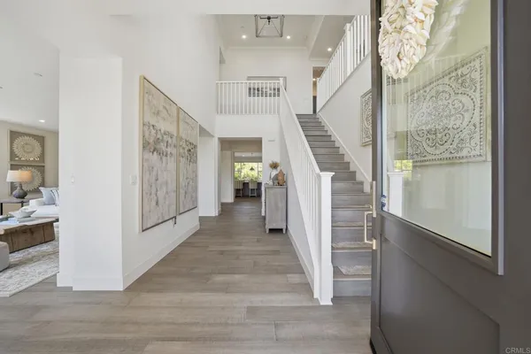 a view of entryway and hall with wooden floor