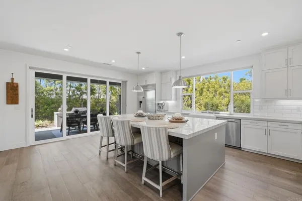a living room with furniture large window and a fireplace