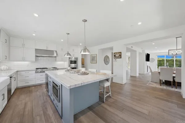 a living room with furniture large window and wooden floor