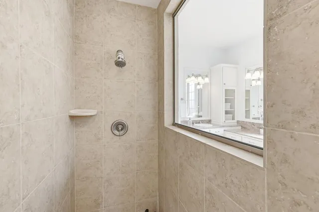 a spacious bathroom with a granite countertop tub sink and mirror