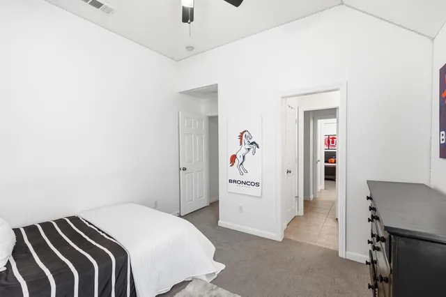 a bedroom with furniture and a flat screen tv