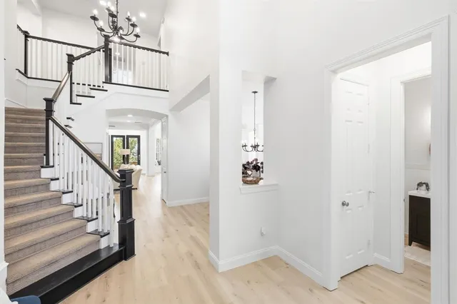 a view of entryway and hall with wooden floor