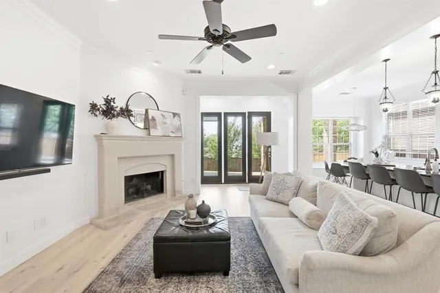 a living room with furniture a fireplace and a flat screen tv