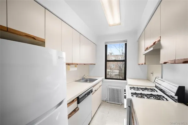 a kitchen with a stove a sink and a refrigerator