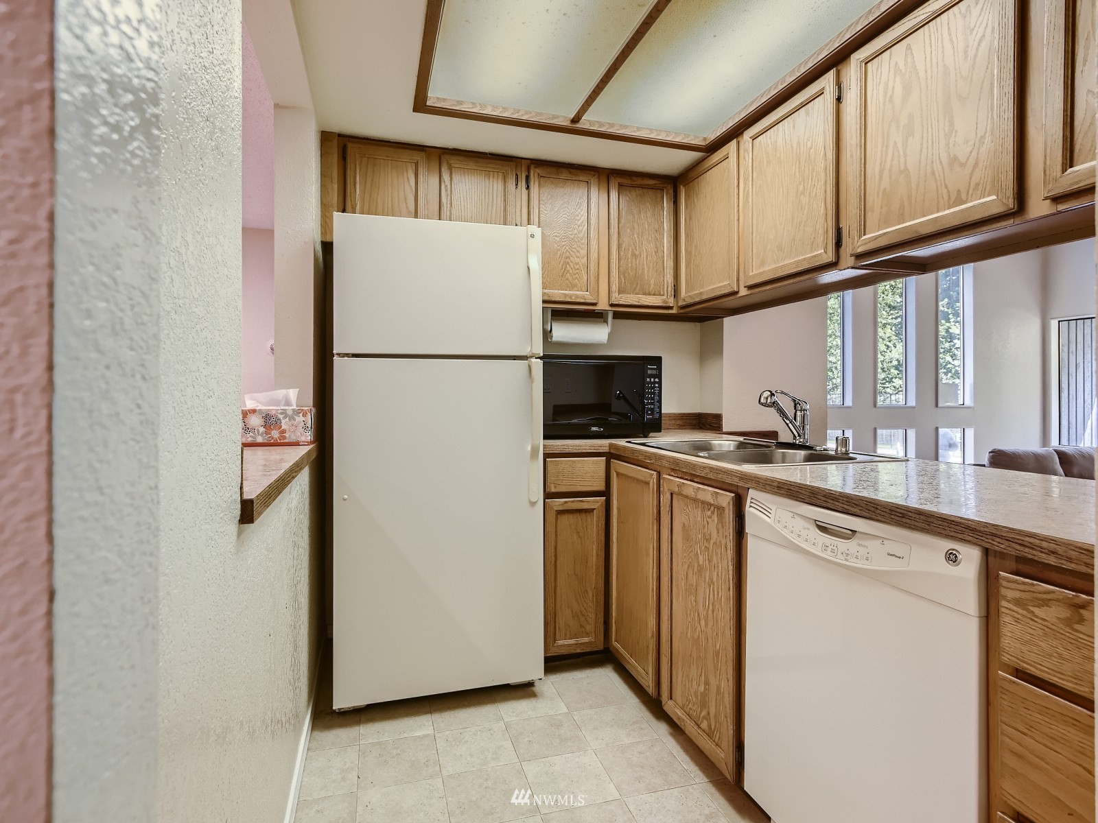 11521 Southeast 175th Street Renton, WA 98058 - Photo 18 of 20 a kitchen with refrigerator a sink and cabinets