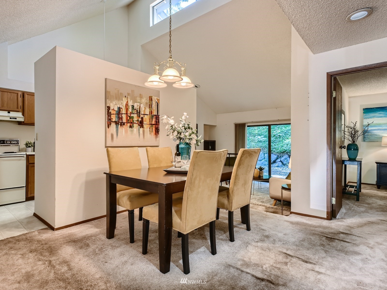 11521 Southeast 175th Street Renton, WA 98058 - Photo 3 of 20 a view of a dining room with furniture and a chandelier