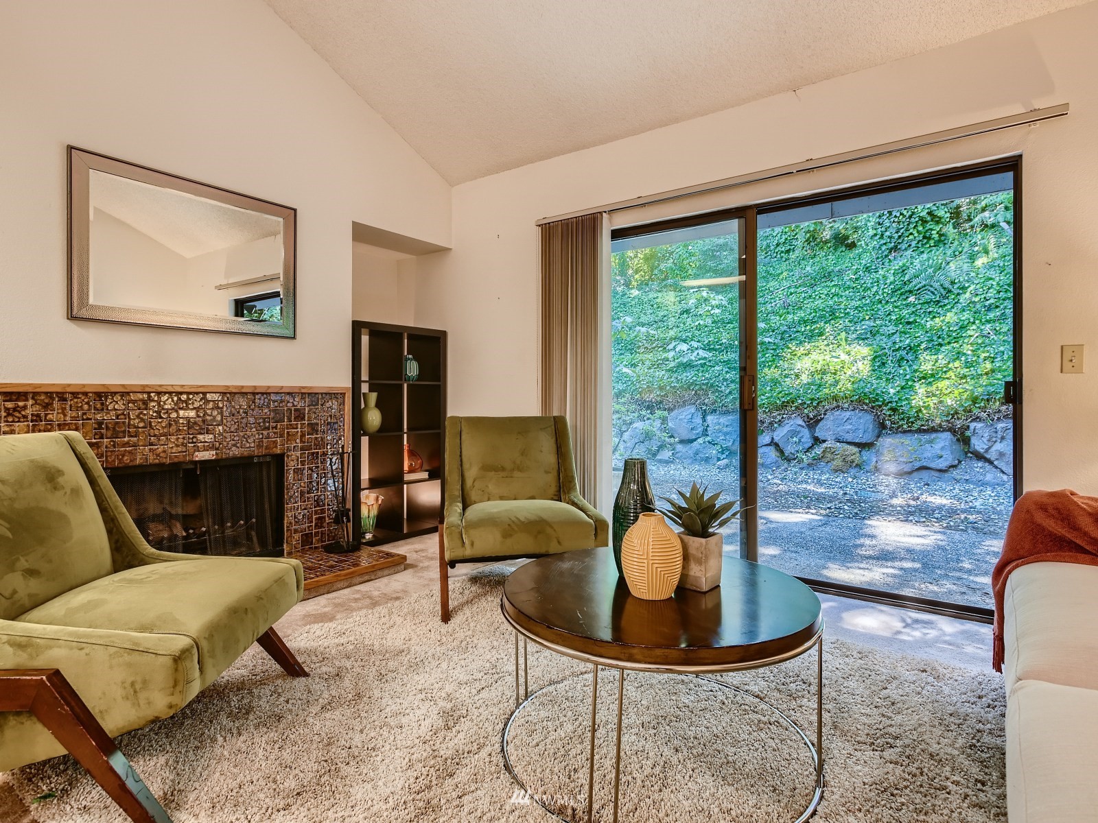 11521 Southeast 175th Street Renton, WA 98058 - Photo 5 of 20 a living room with furniture a fireplace and a floor to ceiling window
