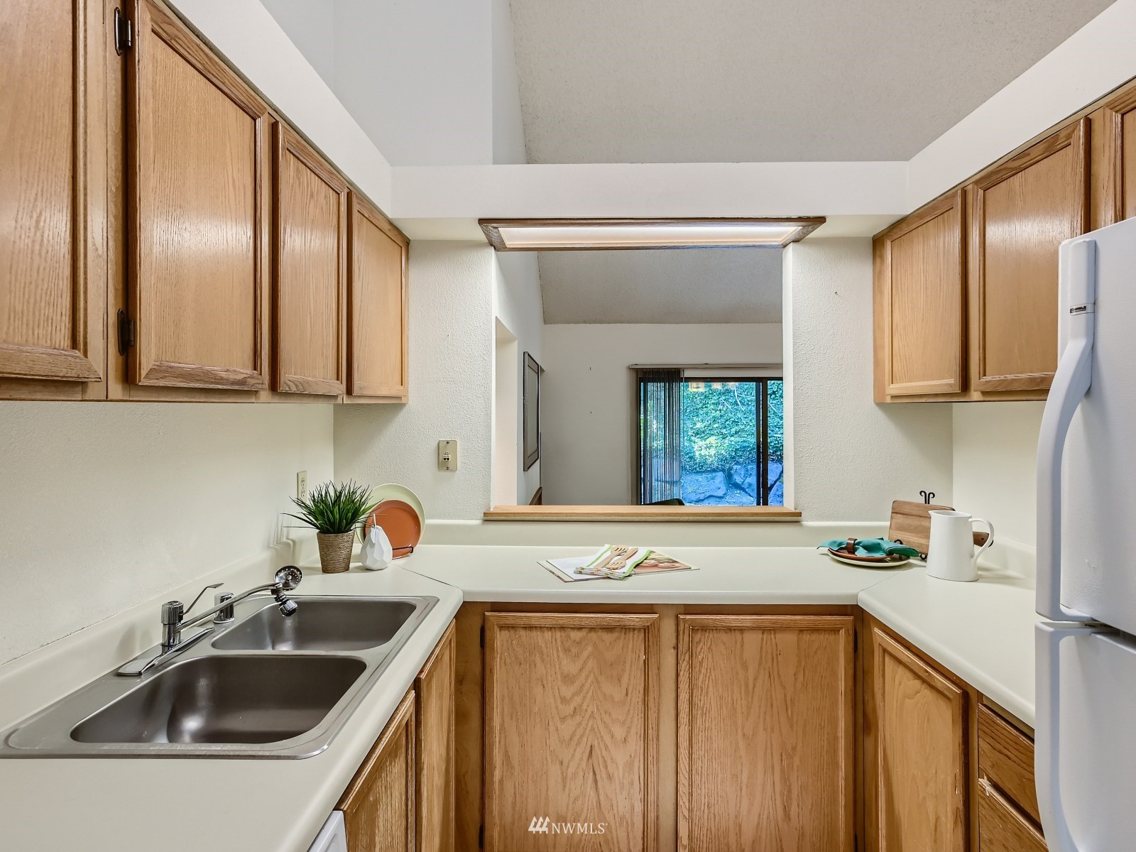 11521 Southeast 175th Street Renton, WA 98058 - Photo 6 of 20 a kitchen with stainless steel appliances a sink a stove and a refrigerator