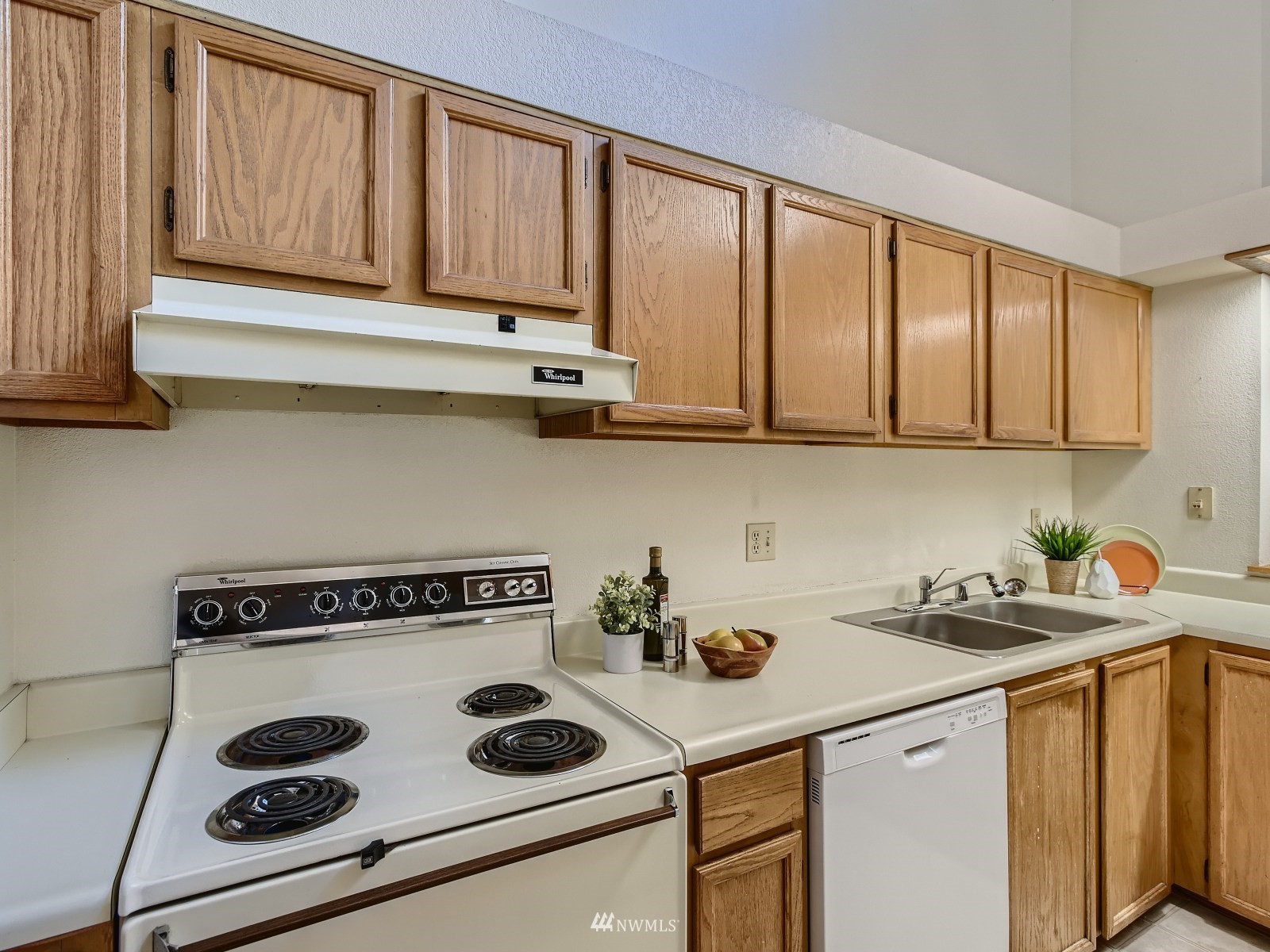 11521 Southeast 175th Street Renton, WA 98058 - Photo 7 of 20 a kitchen with a stove a sink and cabinets
