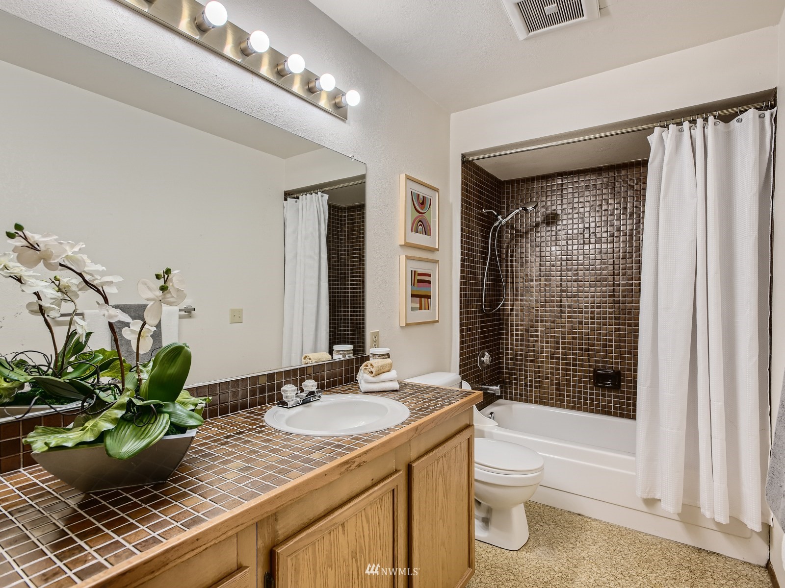 11521 Southeast 175th Street Renton, WA 98058 - Photo 8 of 20 a bathroom with a granite countertop sink a toilet and shower