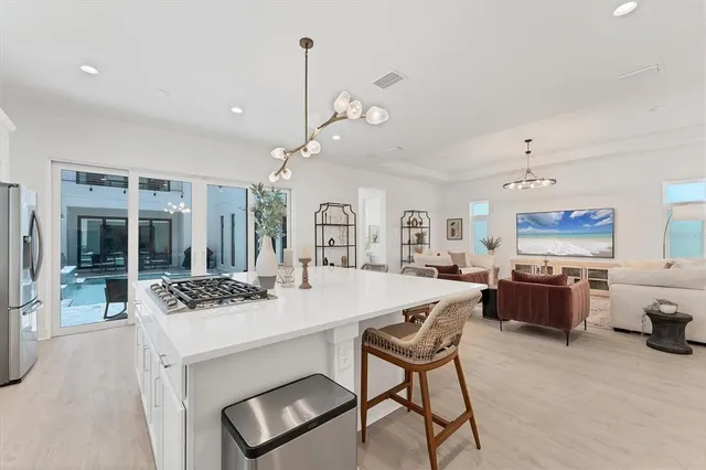 a large white kitchen with lots of counter top space and appliances