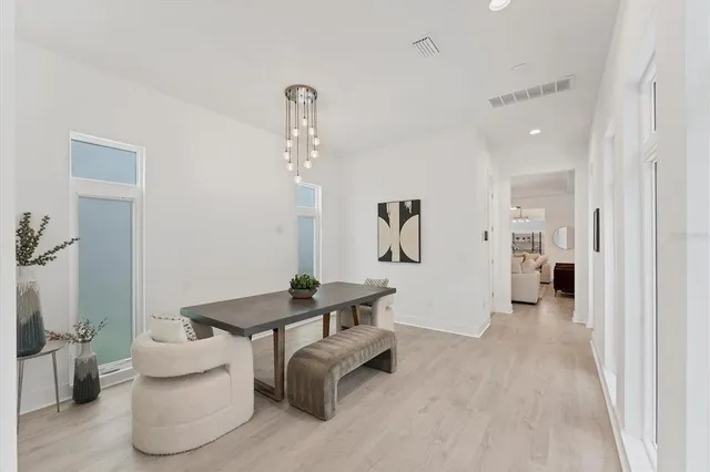 a workspace room with furniture and wooden floor