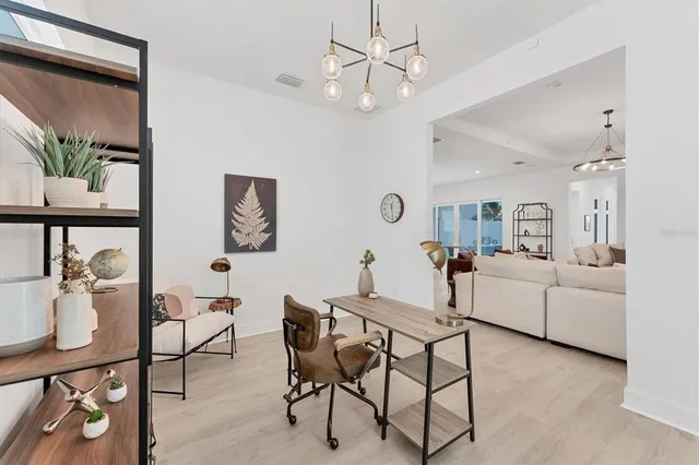 a living room with furniture and a chandelier