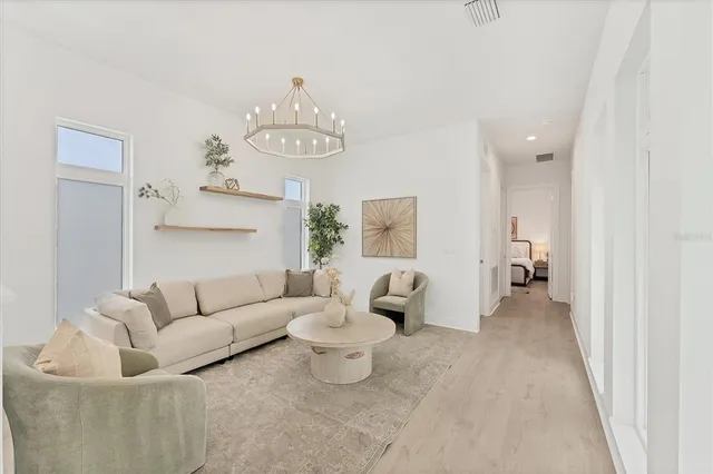 a living room with furniture and a mirror