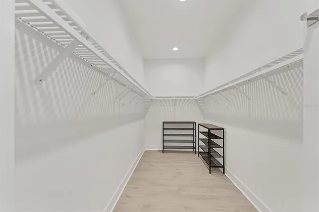 a bathroom with a tub a sink and mirror