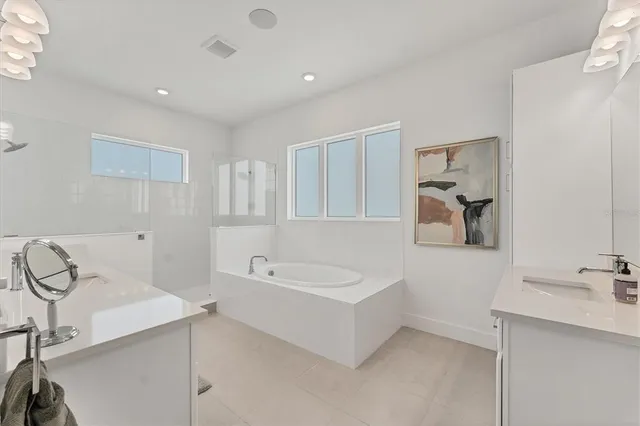 a bedroom with a bed lamp and a large window