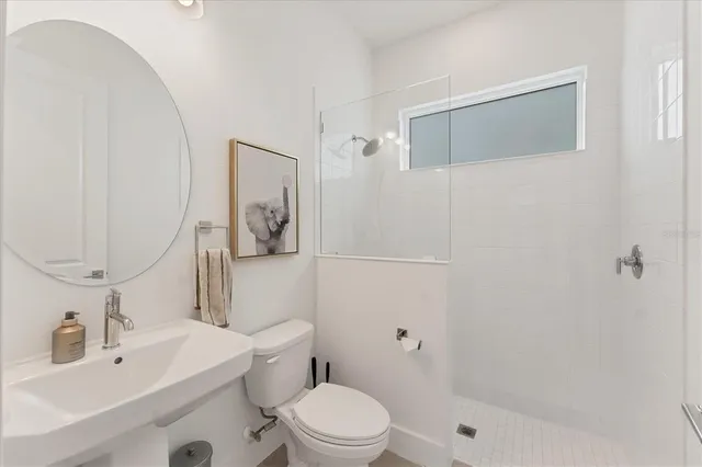 a bathroom with a glass shower door