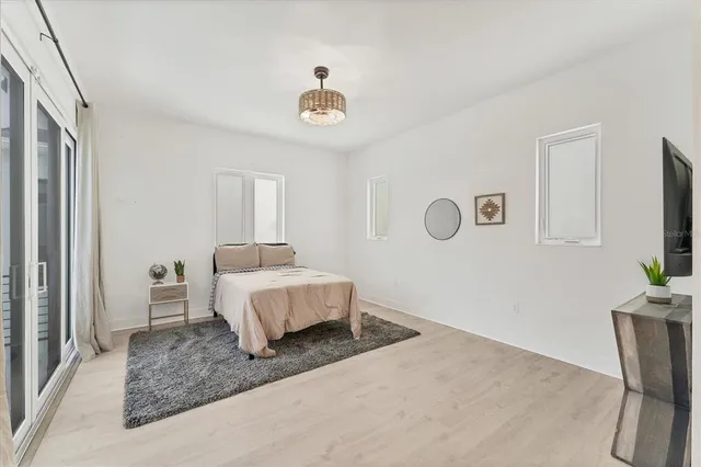 a bedroom with a bed couch and a window