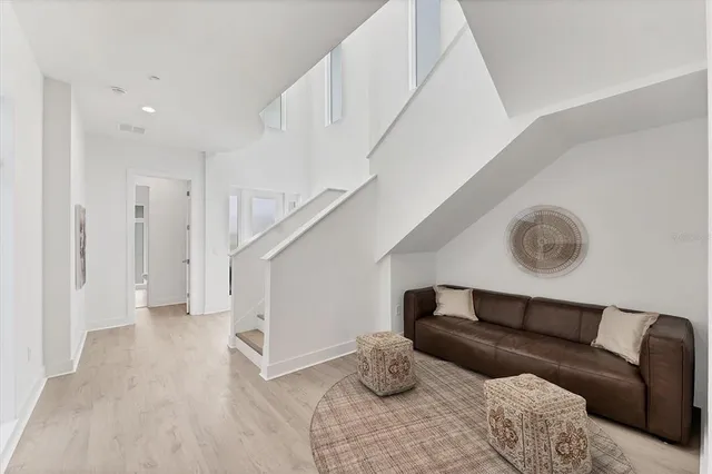 a living room with furniture and a ceiling fan