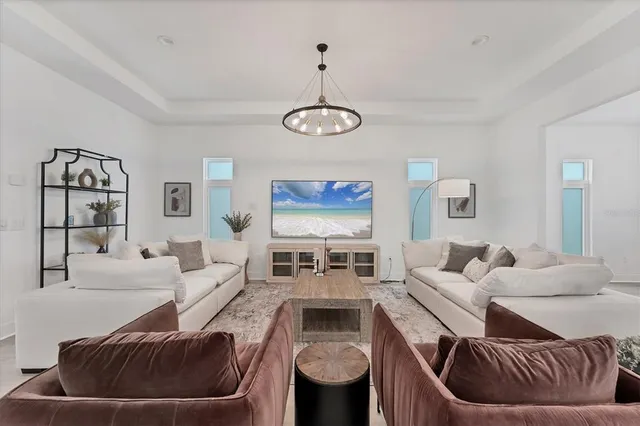 a living room with furniture and a chandelier