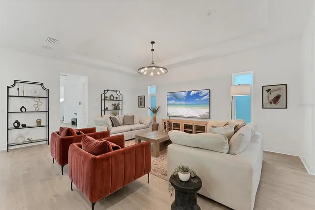 a living room with furniture a rug and a wall painting