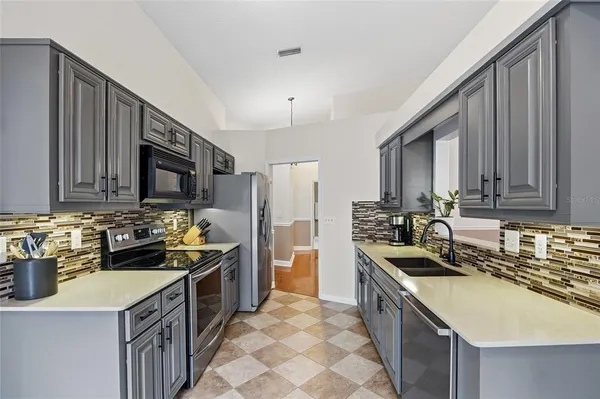 a kitchen with a sink stove and microwave
