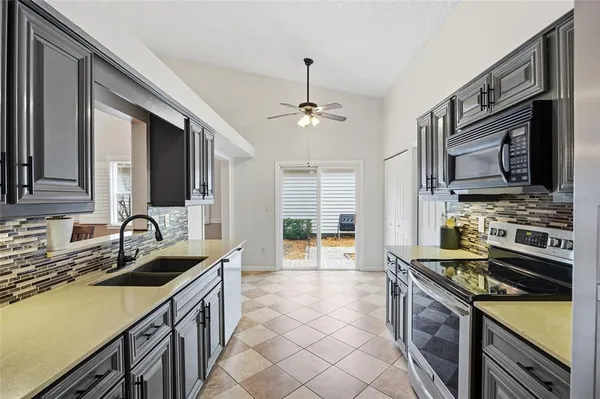 a kitchen that has a sink and a stove