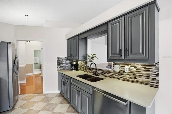 a kitchen with stainless steel appliances kitchen island granite countertop a sink and cabinets