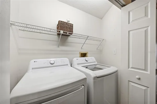 a large white bed sitting in a room next to a window