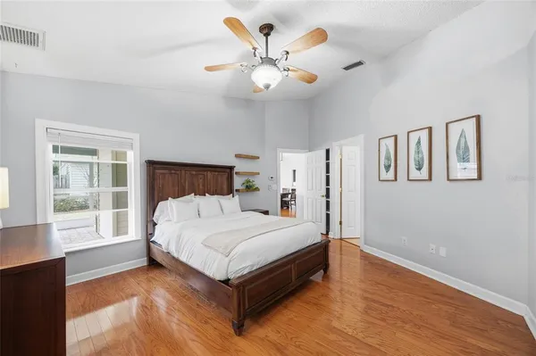 a bedroom with a bed and ceiling fan