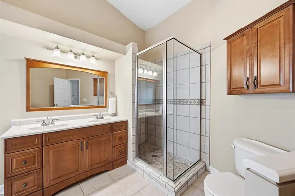a bathroom with a tub a sink and mirror