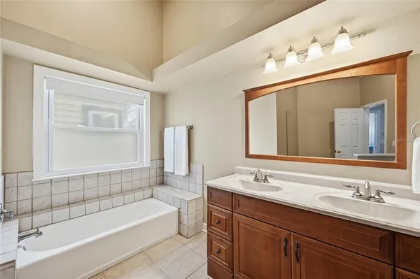 a bathroom with a shower sink and mirror