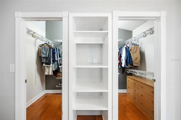 a view of walk in closet with clothes and shoes