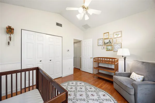a spacious bedroom with a bed and a chandelier