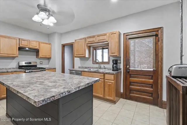 a kitchen with cabinets and chairs