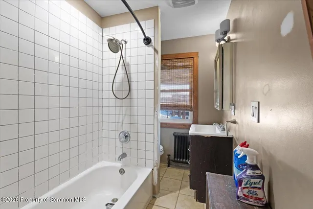 a bathroom with a sink a toilet and a window