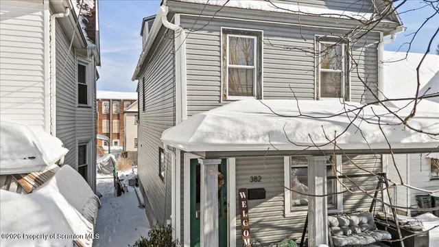 a roof deck with table and chairs