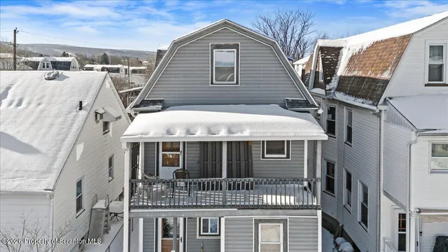 a view of multiple houses with outdoor seating