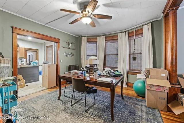 a workspace with wooden floor and a rug