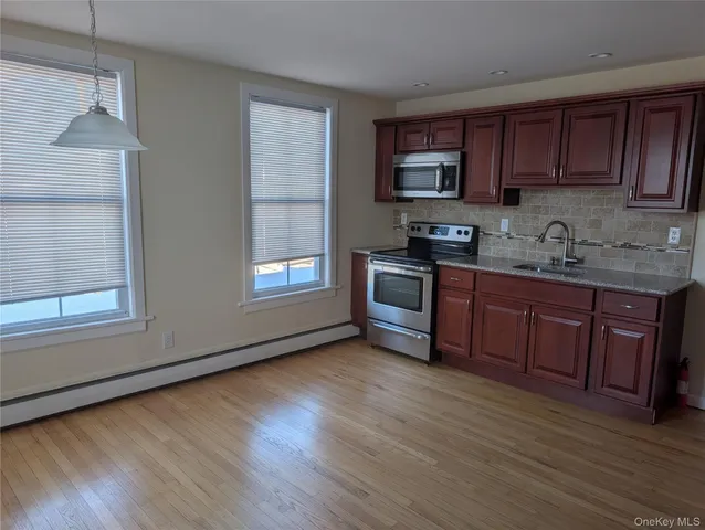 a kitchen with a refrigerator and a sink