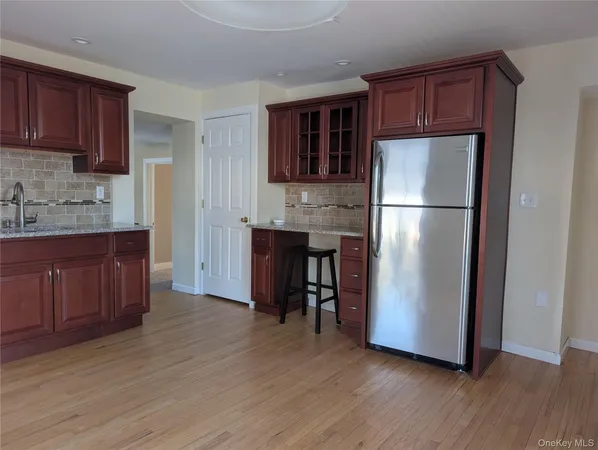 a kitchen with stainless steel appliances granite countertop a sink a microwave and cabinets