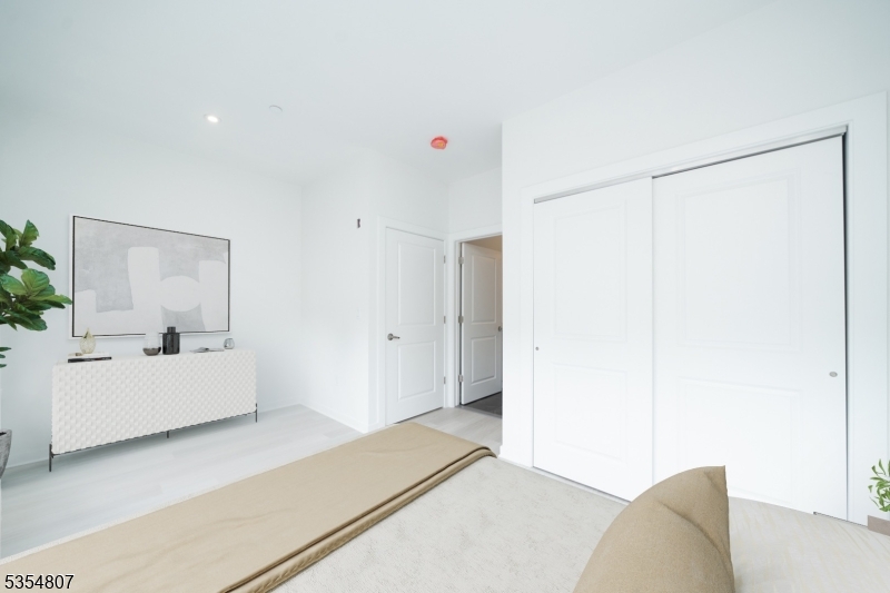 12 River Road, Unit 303 Fair Lawn, NJ 07410 - Photo 6 of 9 a living room with furniture and a wooden floor