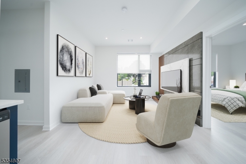 12 River Road, Unit 303 Fair Lawn, NJ 07410 - Photo 7 of 9 a living room with furniture and a large window