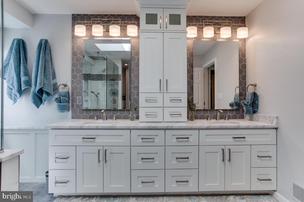 7883 Poplar Grove Road Severn, MD 21144 - Photo 29 of 77 a bathroom with a sink and a mirror