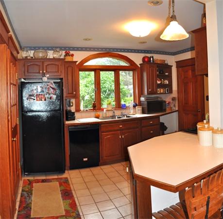 44 Silver Street Greenfield, MA 01301 - Photo 8 of 25 a kitchen with stainless steel appliances kitchen island granite countertop a refrigerator a sink a stove top oven and a dining table with wooden floor