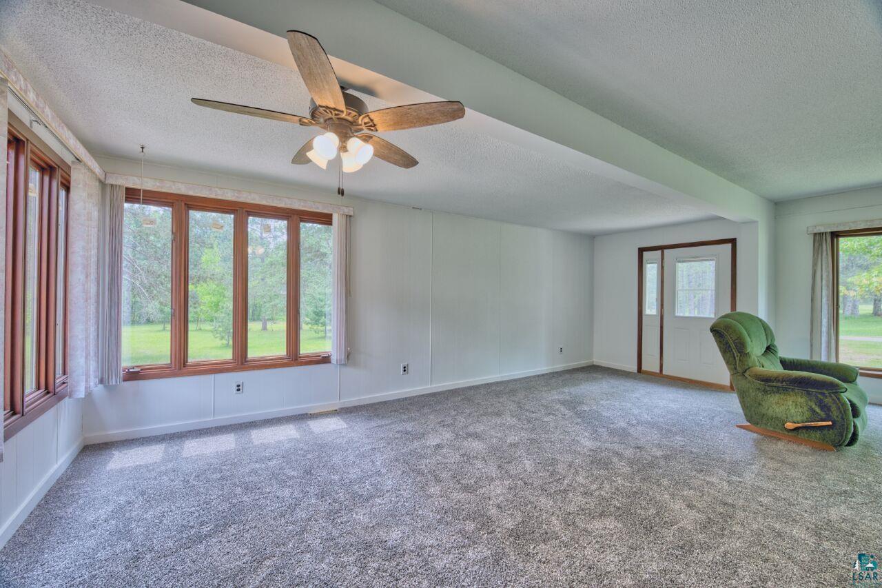 4755 Judd Road Gilbert, MN 55741 - Photo 2 of 50 Unfurnished office featuring a textured ceiling, ceiling fan, carpet, and baseboards