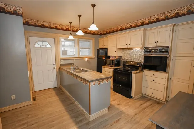 a kitchen with a stove window and cabinets